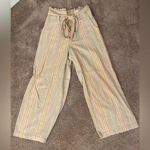 Tan wide leg pants with yellow and pink stripes